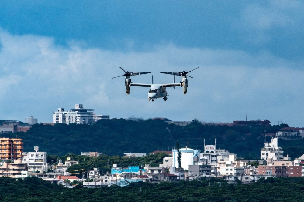A U.S. military Osprey aircraft flies over the Marine Corps Air Station Futenma in the center of the city of Ginowan, Okinawa Prefecture, in August 2022.