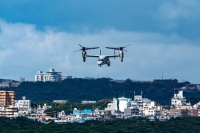 A U.S. military Osprey aircraft flies over the Marine Corps Air Station Futenma in the center of the city of Ginowan, Okinawa Prefecture, in August 2022. | AFP-JIJI