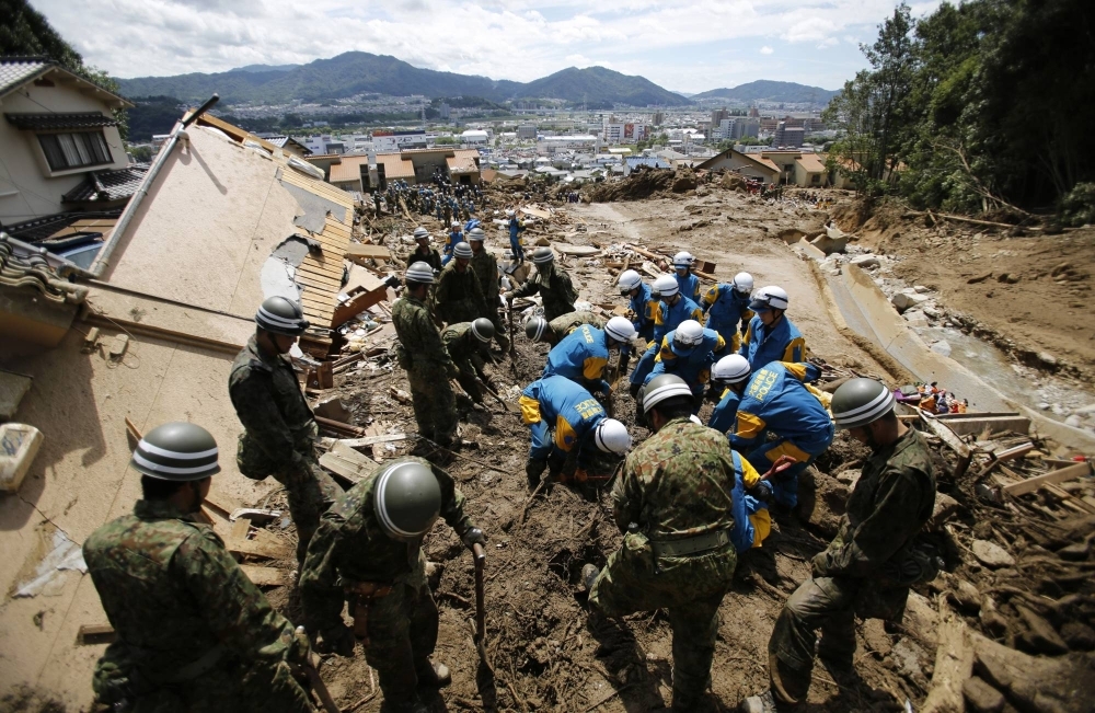 Self-Defense Force soldiers search for survivors after a landslide swept through a residential area in Asaminami Ward, in the city of Hiroshima, in August 2014. Despite the nation’s numerous natural disasters, the government needs better contingency planning.