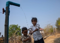Children wash their hands with a new public pump installed as part of a climate resilient water system in Inn Chey in Kratie Province. | Anton L. Delgado
