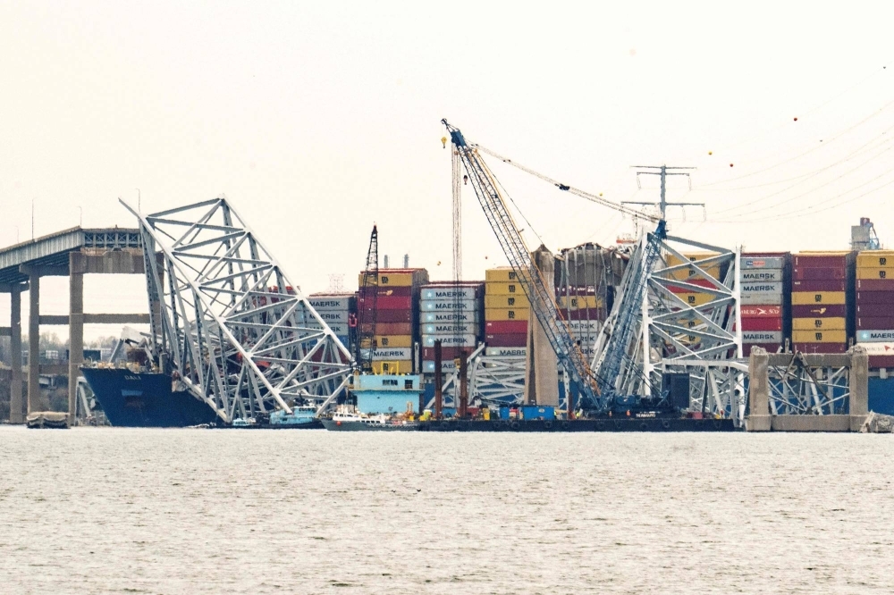Cranes begin the clean-up of the collapsed Francis Scott Key Bridge and the container ship Dali in Baltimore, Maryland, on Saturday.