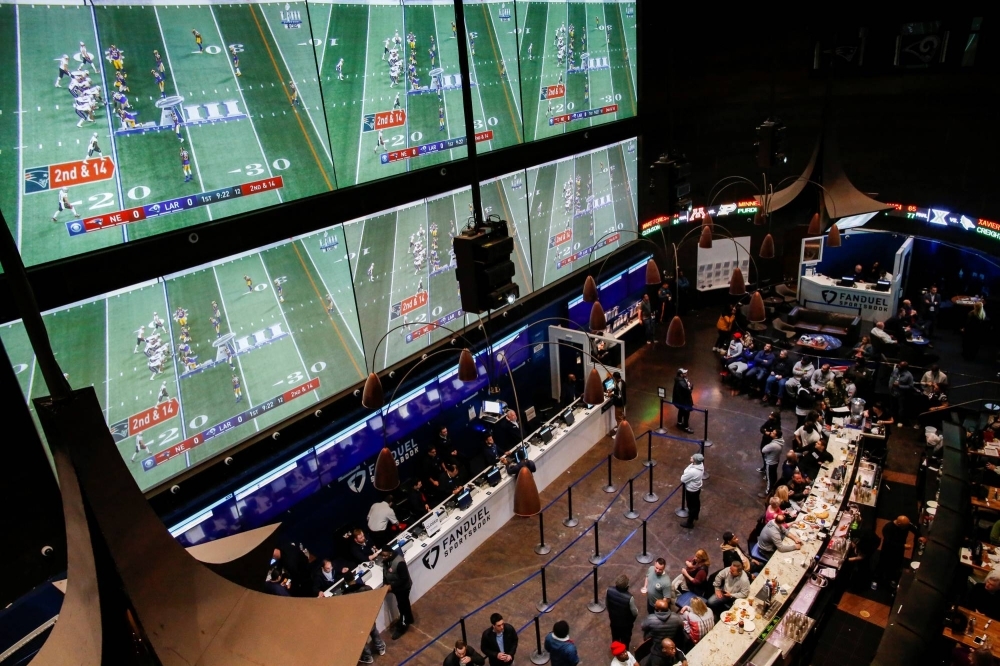 People place their bets at the Fanduel sportsbook in East Rutherford, New Jersey, during the Super Bowl in February 2019. 