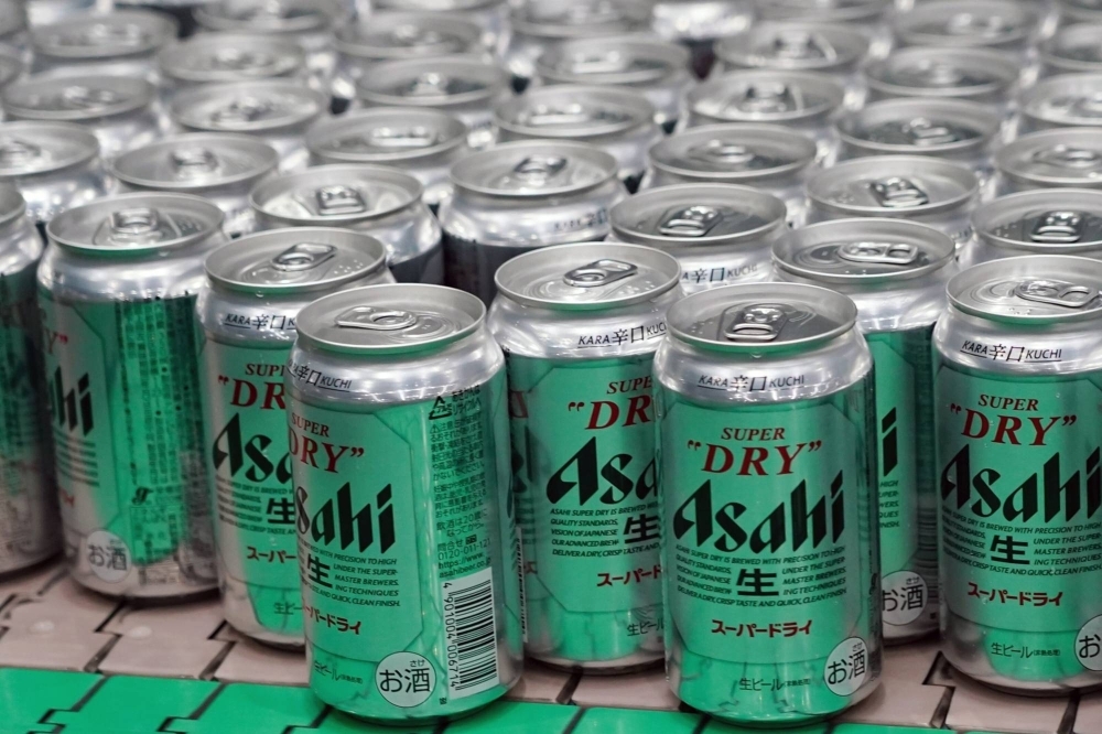 Cans of Asahi Super Dry beer move on the production line inside an Asahi Breweries plant in Moriya, Ibaraki Prefecture, in April 2023.