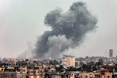 A smoke plume erupts during Israeli bombardment on Khan Yunis as seen from Rafah in the southern Gaza Strip on Friday. 