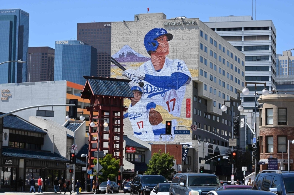 A mural showing Dodgers player Shohei Ohtani is seen on the side of the Miyako Hotel in Little Tokyo, downtown Los Angeles, on Thursday. The mural is by artist Robert Vargas and is 46 meters tall.