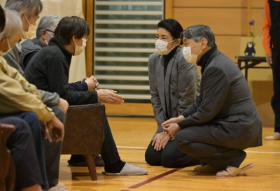 Emperor Naruhito and Empress Masako speak with evacuees at a junior high school serving as an evacuation shelter in Suzu, Ishikawa Prefecture, on March 22.