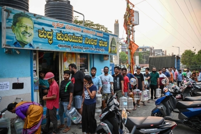 People wait to collect drinking water on March 14 amid an ongoing water crisis in Bengaluru, which has been hit by drought.