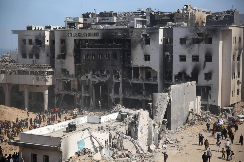 Palestinians inspect the damage at Gaza's Al-Shifa hospital after the Israeli military withdrew from the complex housing the hospital on Monday.