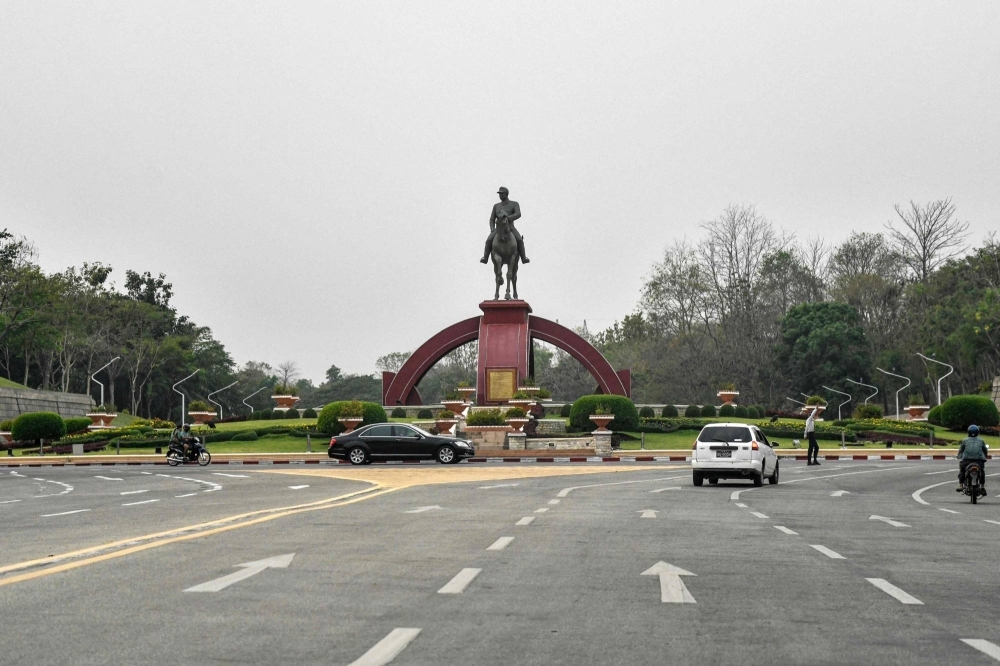 Cars drive past the statue of General Aung San in Nay Pyi Taw, Myanmar, on March 26.