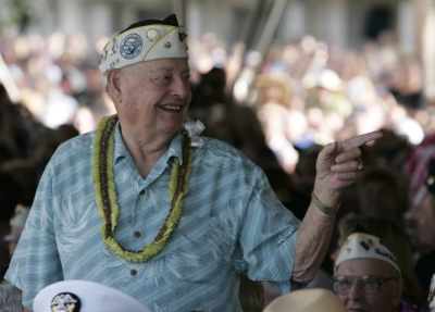 Pearl Harbor survivor Lou Conter gestures to a fellow survivor during the wreath laying presentation for the 70th anniversary of the attack on Pearl Harbor at the World War II in Honolulu, Hawaii, on Dec. 7, 2011. 