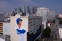 A giant mural of baseball star Shohei Ohtani appears on the side of a hotel in downtown Los Angeles in March. ANA Holdings said it has reached a multi-year deal to be the official Japanese airline for the Los Angeles Dodgers. | Reuters