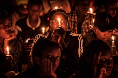People hold candles as they attend a night vigil and prayer at the Amahoro Stadium as part of the 25th Commemoration of the 1994 Genocide, in Kigali, Rwanda, on April 7, 2019. Rwanda will soon commemorate the 30th anniversary this year.