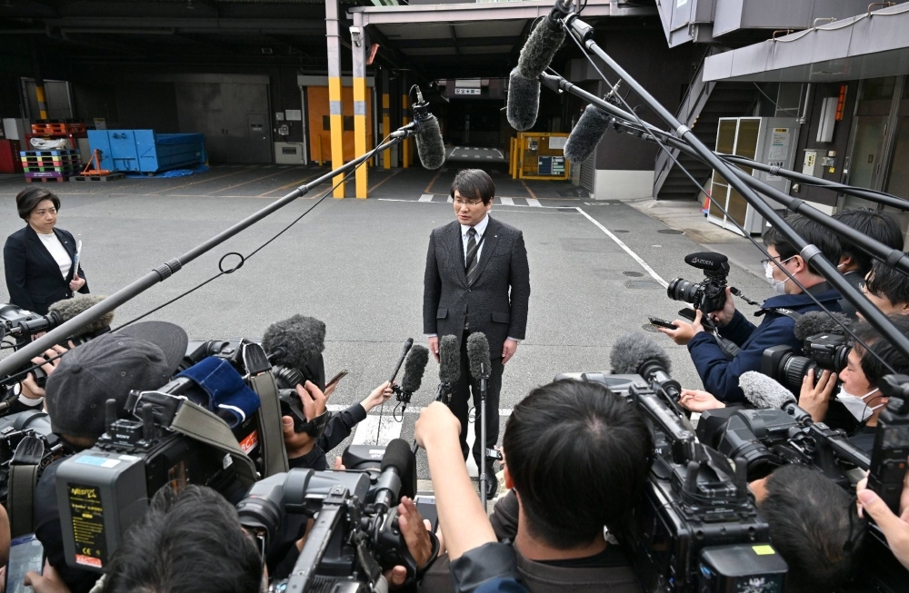 An official of Kobayashi Pharmaceutical speaks to reporters on Saturday in Osaka following the health ministry's inspections of the firm's plant.