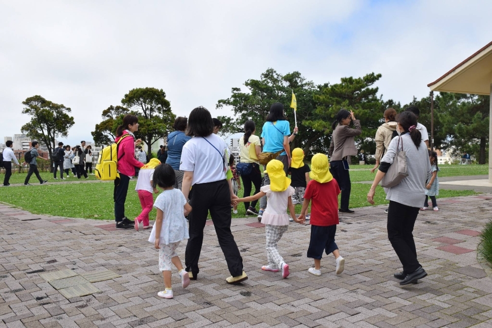 Children are evacuated from a preschool in Naha, Okinawa Prefecture, following tsunami warnings after a powerful earthquake struck off Taiwan on Wednesday morning.