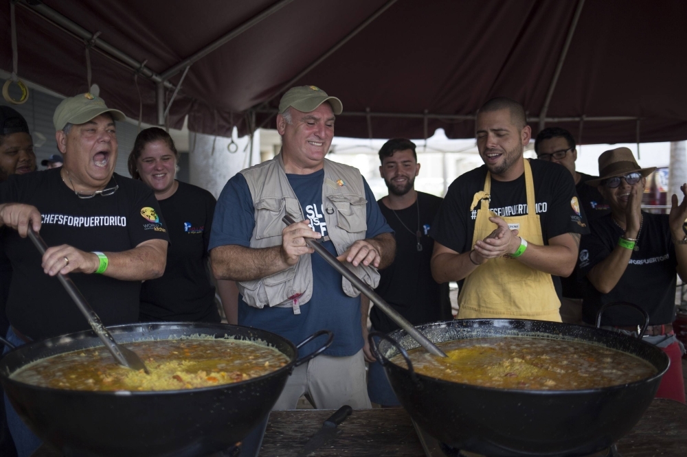 Chef Jose Andres (center) and local chefs stir large pots of paella destined for people struggling to find enough to eat in the wake of Hurricane Maria, in San Juan, Puerto Rico, in October 2017.