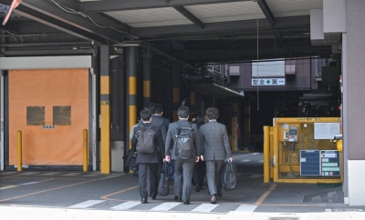Health ministry officials enter Kobayashi Pharmaceutical's Osaka plant on Saturday for inspection.