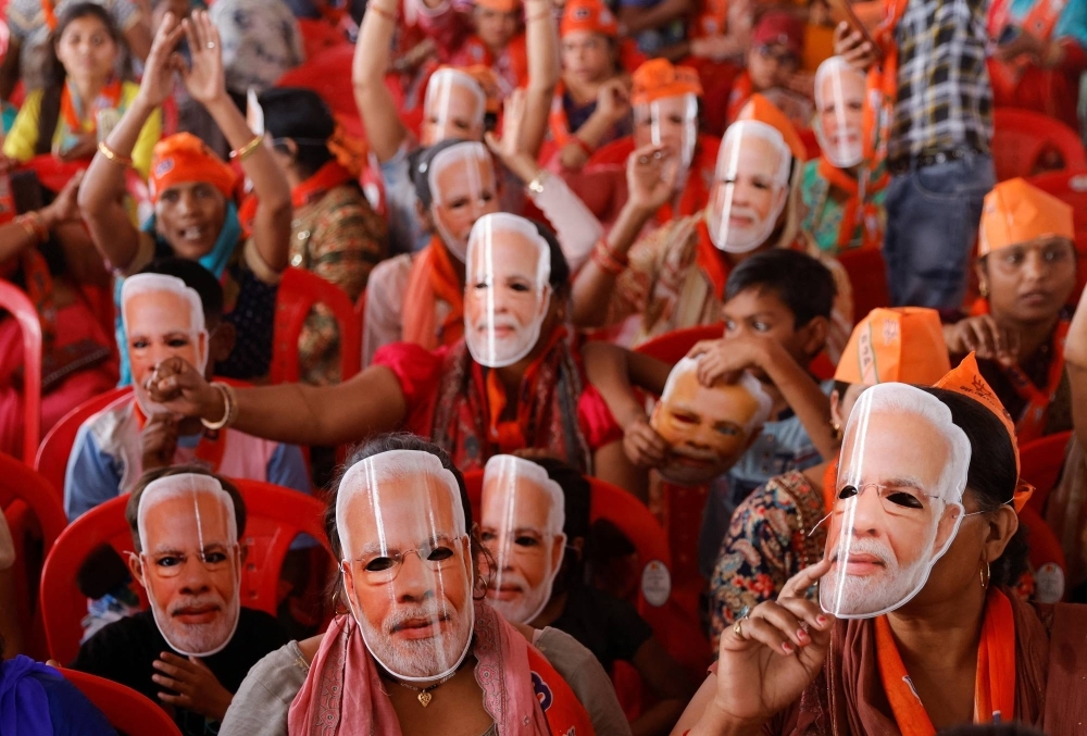 Supporters of India's Prime Minister Narendra Modi wear masks of his face at an election campaign rally in the city of Meerut, in the Indian state of Uttar Pradesh, on March 31.