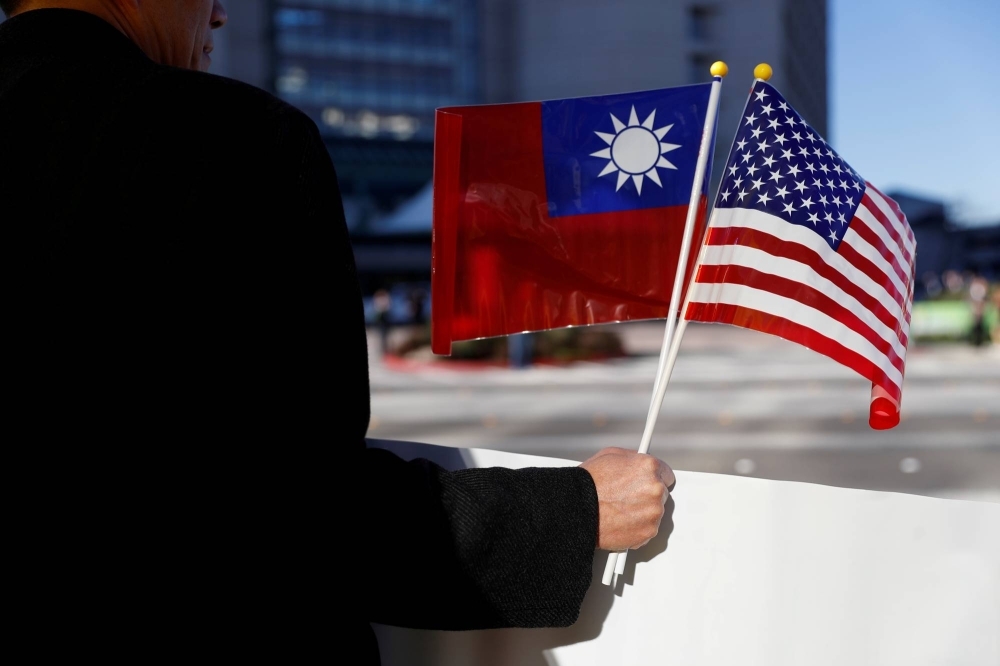 A demonstrator holds flags of Taiwan and the United States in support of Taiwanese President Tsai Ing-wen during an stopover after her visit to Latin America, in Burlingame, California, in January 2017.