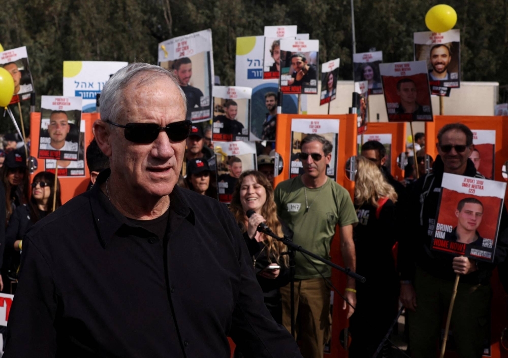 Israeli Defense Minister Benny Gantz walks as families and supporters of hostages kidnapped in the deadly Oct. 7 attack on Israel by the Palestinian Islamist group Hamas take part in a four-day march from Reim to Jerusalem as they call for the release of hostages, near Beit Shemesh, Israel, on March 1.