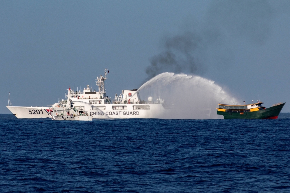 China Coast Guard vessels fire water cannons toward the Philippine resupply vessel Unaizah May 4 on its way to Second Thomas Shoal in the disputed South China Sea on March 5.