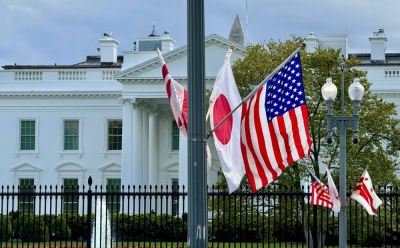 U.S., Japanese and District of Columbia flags are seen on a lamp post near the White House in Washington on Thursday in preparation for next week's official state visit of Prime Minister Fumio Kishida.