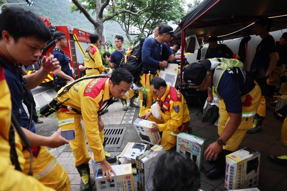 Rescuers prepare supplies before entering Taroko National Park after an earthquake in Hualien, Taiwan.