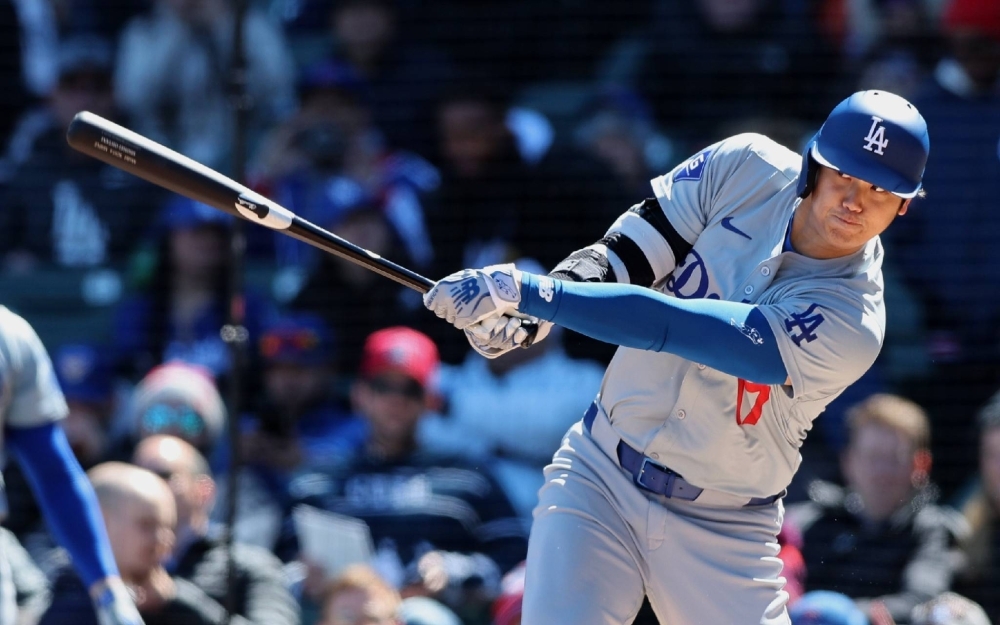 The Los Angeles Dodgers' Shohei Ohtani doubles in the Dodgers' 9-7 loss to the Chicago Cubs on Friday in Chicago.
