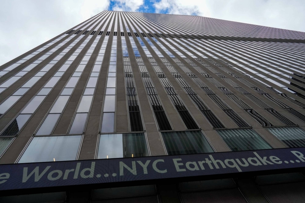 A screen on the News Corp. building shows the news after an earthquake shook New York City on Friday.