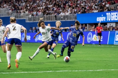 United States defender Casey Short (20) and Japan midfielder Aoba Fujino (15) run for the ball during the second half at Mercedes-Benz Stadium in Atlanta, Georgia, on Saturday.