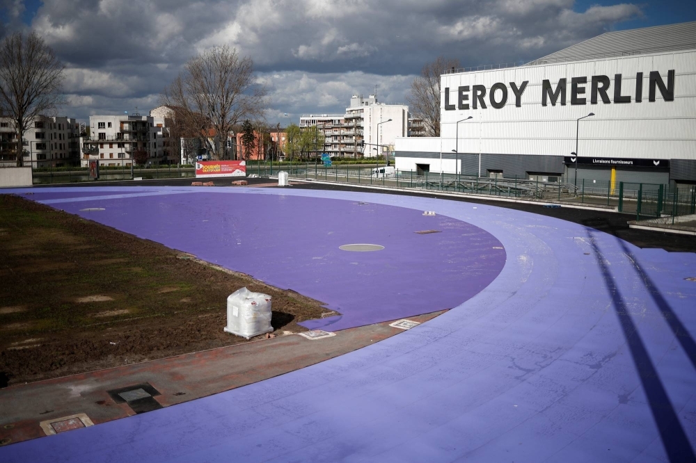 A Paris 2024 Olympic and Paralympic Games' athletics track in two shades of purple is installed next to the Stade de France stadium in Saint-Denis, near Paris, on March 24.