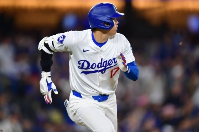 Dodgers designated hitter Shohei Ohtani runs out a fly ball against the San Francisco Giants at Dodger Stadium in Los Angeles on Wednesday.