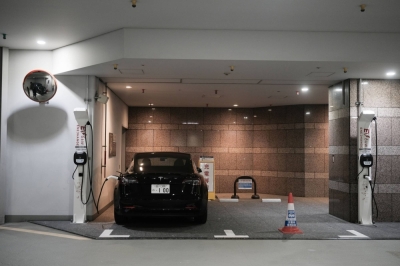 A lone Tesla charges in the basement of a commercial property in Tokyo. One of Japan’s biggest obstacles to electric vehicles is subpar charging infrastructure.
