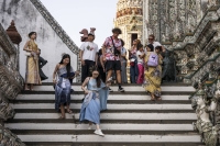 Tourists visit Wat Arun Ratchawararam Ratchawaramahawihan in Bangkok in January. | Bloomberg