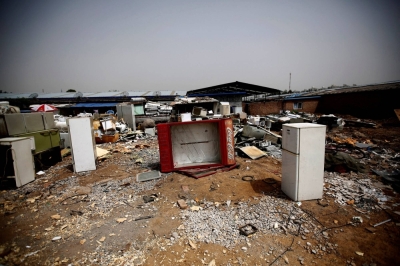 Broken fridges in the yard of a recycling workers' tenement house in Dongxiaokou village in Beijing in 2014