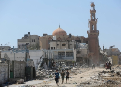 Palestinians inspect destroyed residential buildings and a mosque in Khan Younis, in the southern Gaza Strip on Sunday. 