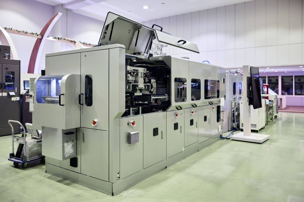 Towa’s compression molding equipment. The firm commands two-thirds of the world’s chip molding equipment market.