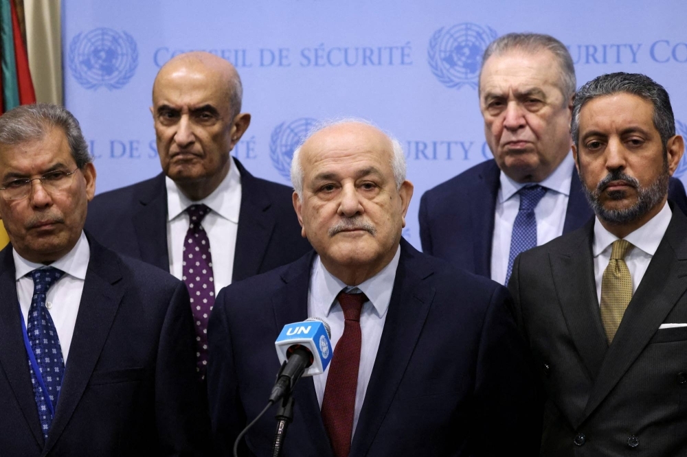 Palestinian Ambassador to the United Nations Riyad Mansour speaks with the media, accompanied by Yemen's Ambassador to the United Nations Abdullah Ali Fadhel Al-Saadi and Algeria's Representative to the United Nations Amar Bendjama, at U.N. headquarters in New York on March 25.
