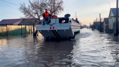 Rescuers search for residents to evacuate as they drive in a flooded residential area in the city of Orsk, Russia, on Saturday. 