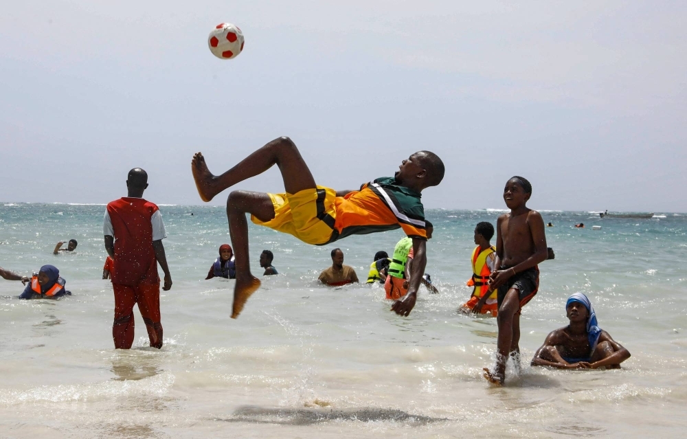 A reveller plays football at Liido beach in Mogadishu, Somalia, on February 23.