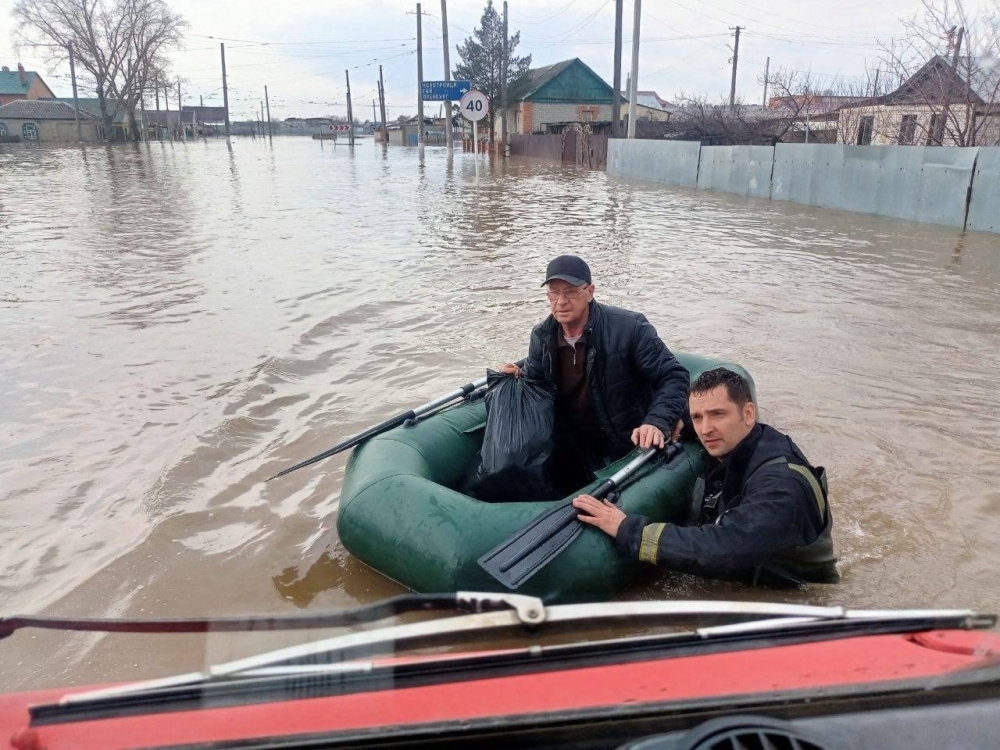 Rescuers cross a flooded street on their way to evacuate residents during a flood in the town of Orsk, southeast of the southern tip of the Ural Mountains on April 6.
