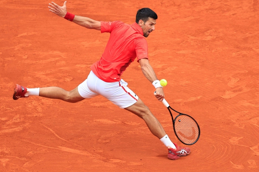 Serbia's Novak Djokovic plays a backhand return during his win over Russian Roman Safiullin on Tuesday at the Monte Carlo Masters in Monaco. 