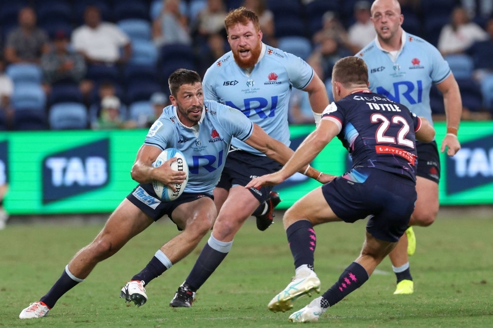 New South Wales Waratahs' Jake Gordon runs with the ball during his club's Super Rugby match against the Melbourne Rebels in Sydney on March 29. 