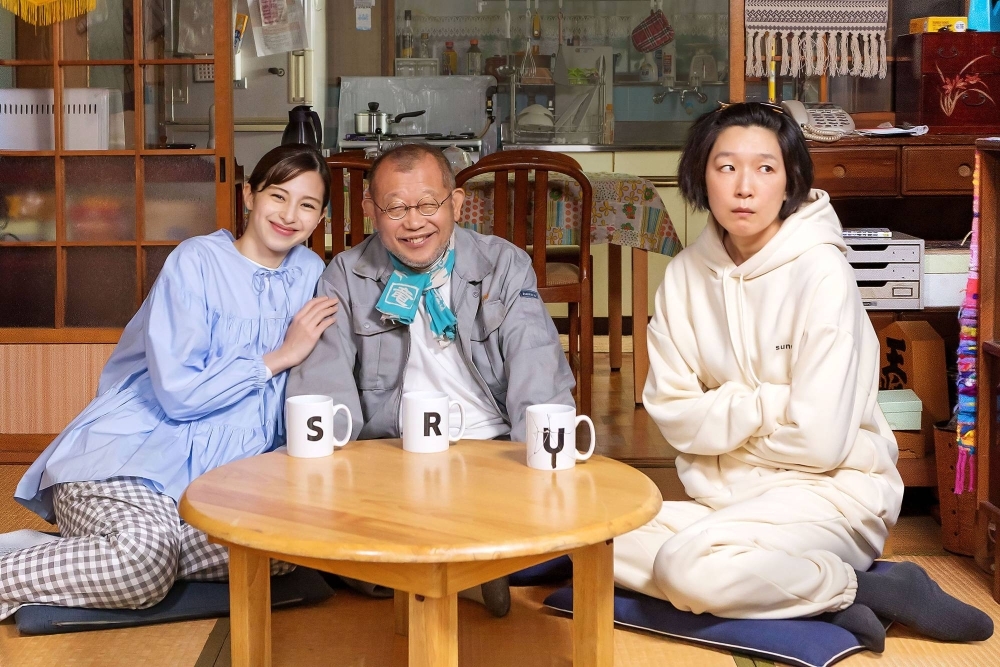 Discomfort and life lessons ensue after a 60-something-year-old man (Shofukutei Tsurube, center) marries a much younger woman (Ayami Nakajo, left) while living with his 39-year-old daughter (Noriko Eguchi) in “Amalock.”