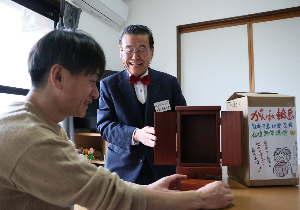 Koki Nagata (right) offers a Buddhist altar to a Noto Peninsula earthquake evacuee in Kanazawa, Ishikawa Prefecture, on March 29.