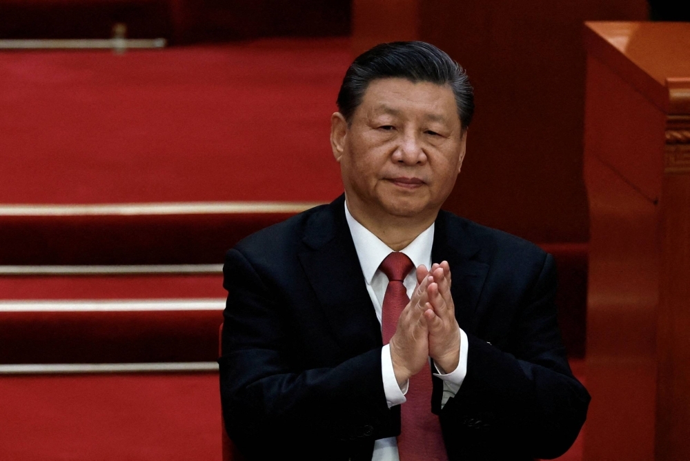 Chinese President Xi Jinping applauds at the closing session of the National People's Congress at the Great Hall of the People in Beijing on March 11.