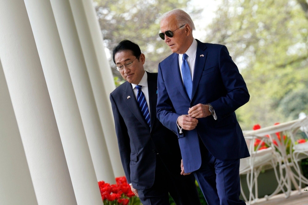 Prime Minister Fumio Kishida and U.S. President Joe Biden arrive for a news conference during a state visit at White House in Washington on Wednesday.