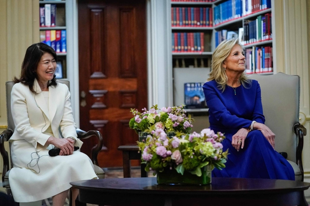 Yuko Kishida, wife of Prime Minister Fumio Kishida, and U.S. first lady Jill Biden listen to students read poetry during an event with local high school students at a White House library in Washington on Wednesday.