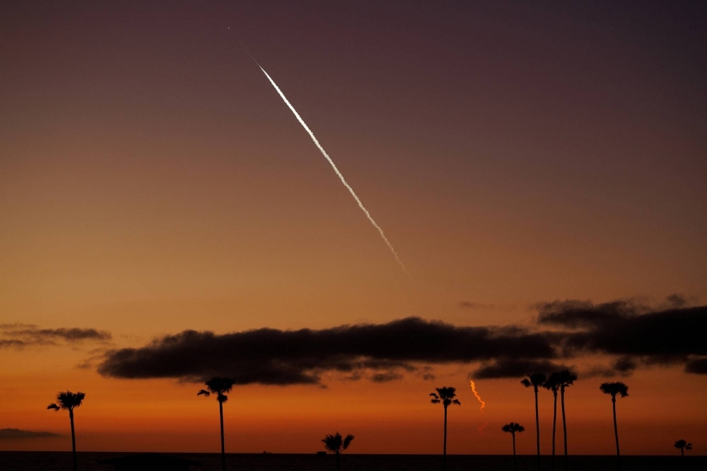 An evening launch of a SpaceX Falcon 9 rocket carrying 22 Starlink satellites to low-Earth orbit as seen from Encinitas, California, on April 1.
