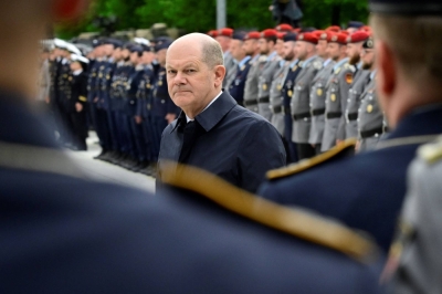 German Chancellor Olaf Scholz reviews soldiers of the German armed forces in Berlin on Thursday.