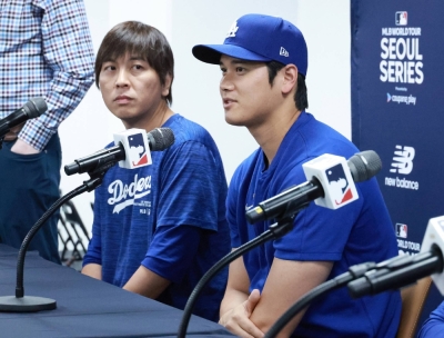Ippei Mizuhara and Dodgers star Shohei Ohtani attend a news conference ahead of MLB's season-opening series in Seoul on March 16.